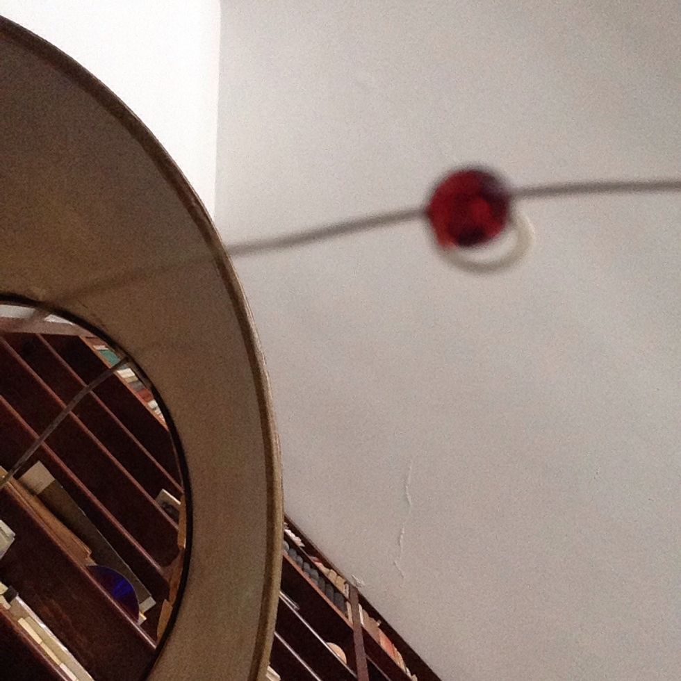 Pull both wire ends to snug the wire loop around the bead