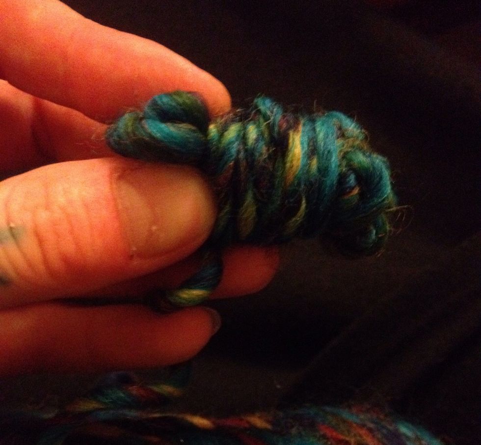 Pull bundle off your fingers and wrap it around the middle. Continue wrapping around until ball forms