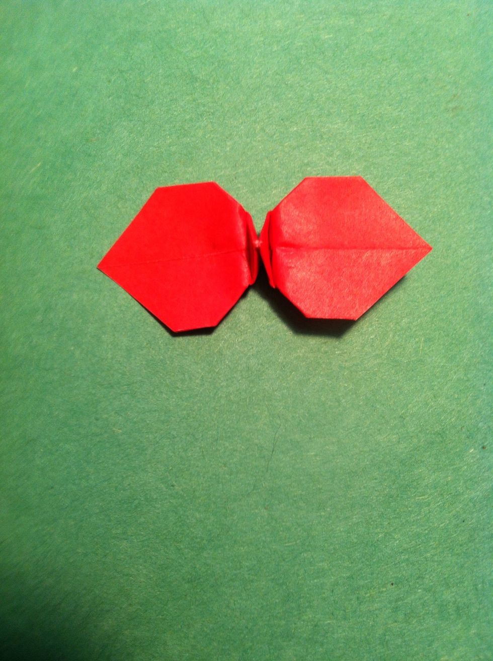 Pull carefully on the tips & squish the center point down...