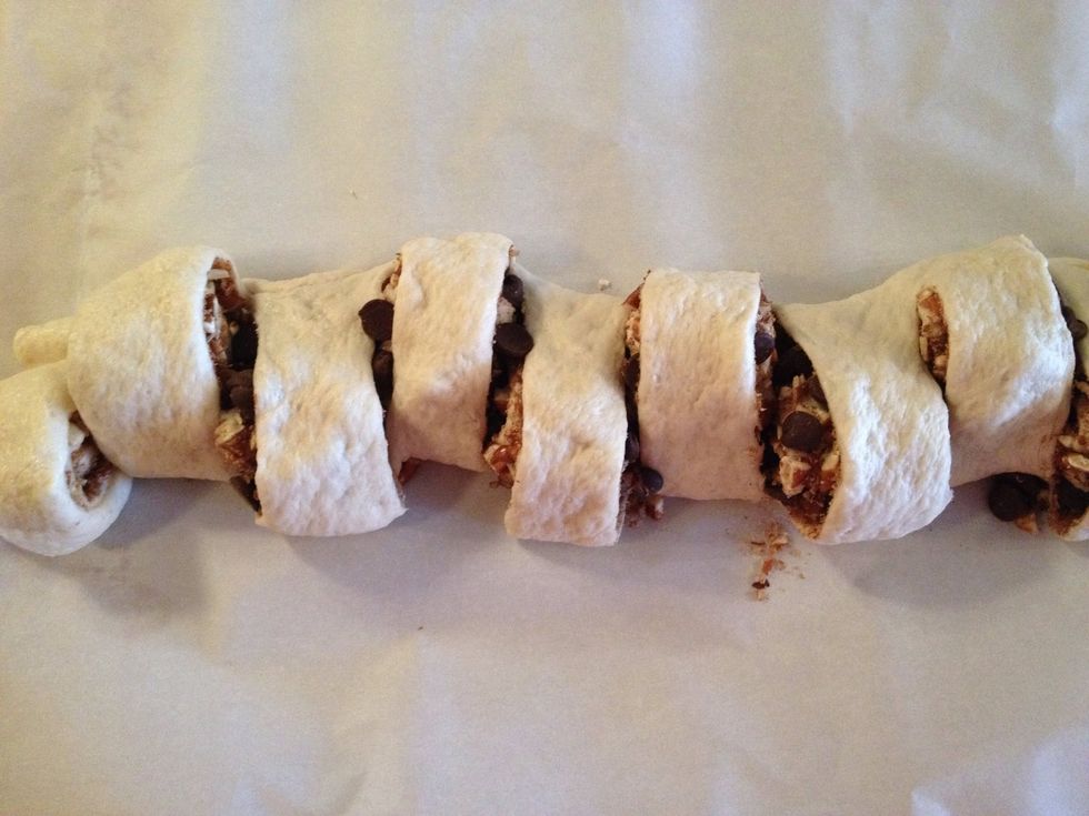 Pull cut slices sideways to lean to alternating sides. Bake in oven for 20 minutes or until golden brown at 400 degrees