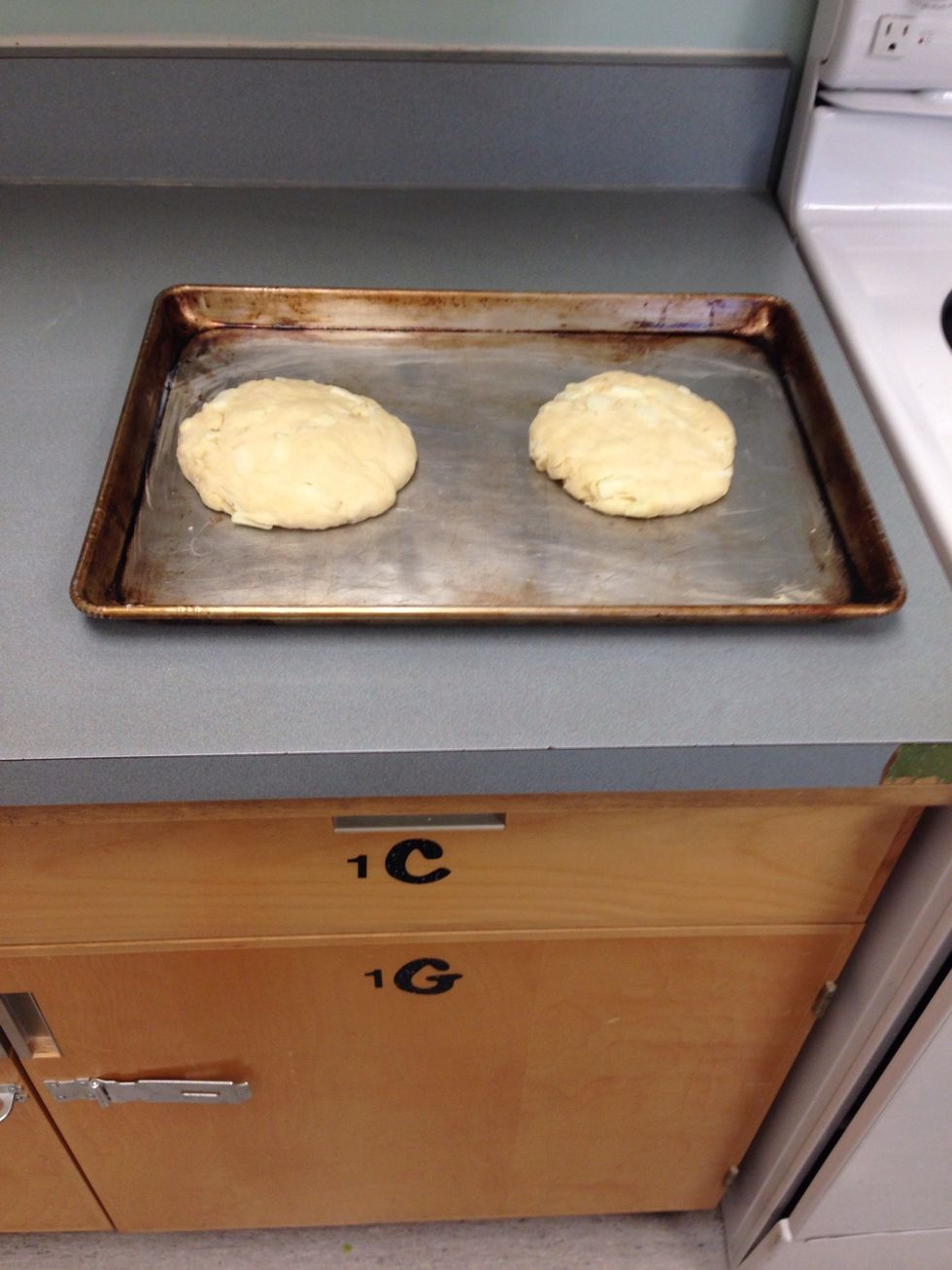 Pull dough apart to form two circles and place them on a greased baking sheet