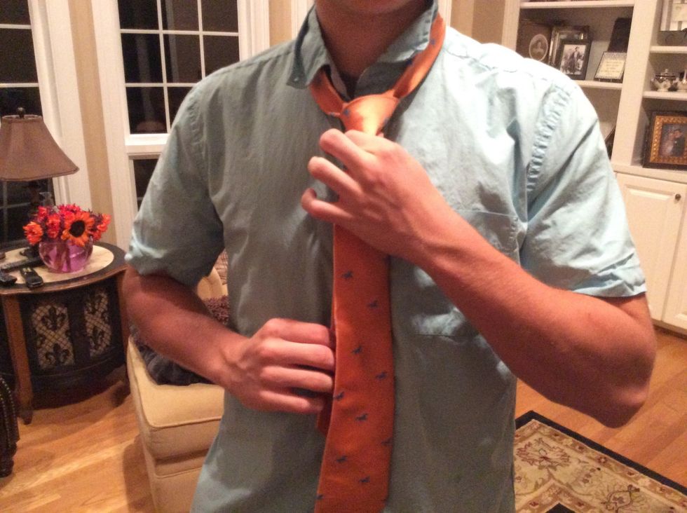 Pull down on the fat end to tighten and slide the knot to adjust