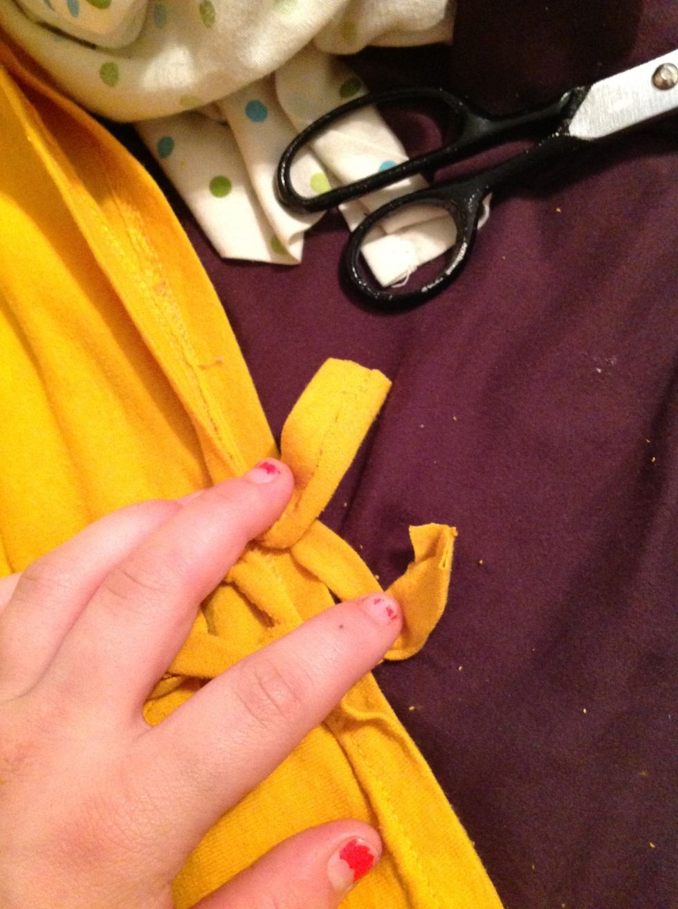 Pull each of the two sections over the last one and tie them in a double knot