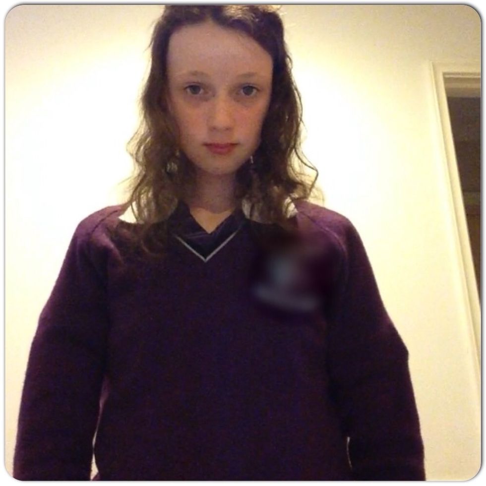 Pull half of your hair up and tie it with a hair tie