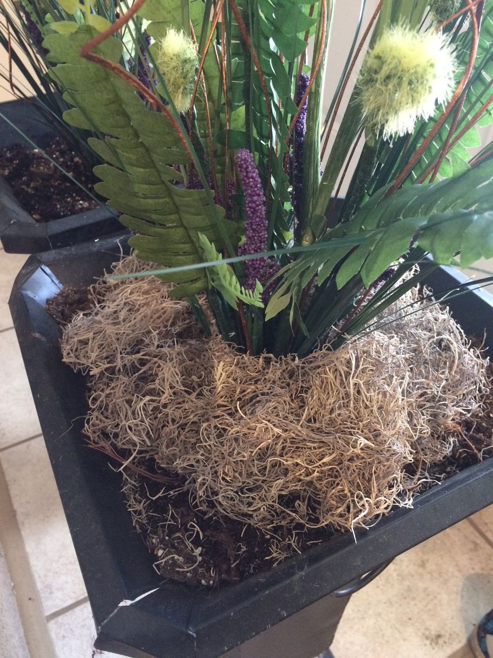 Pull it apart so it surrounds the arrangement.
