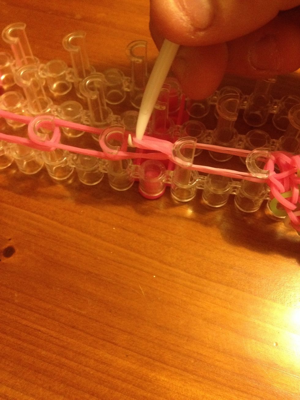 Pull It back over itself on to the next hook