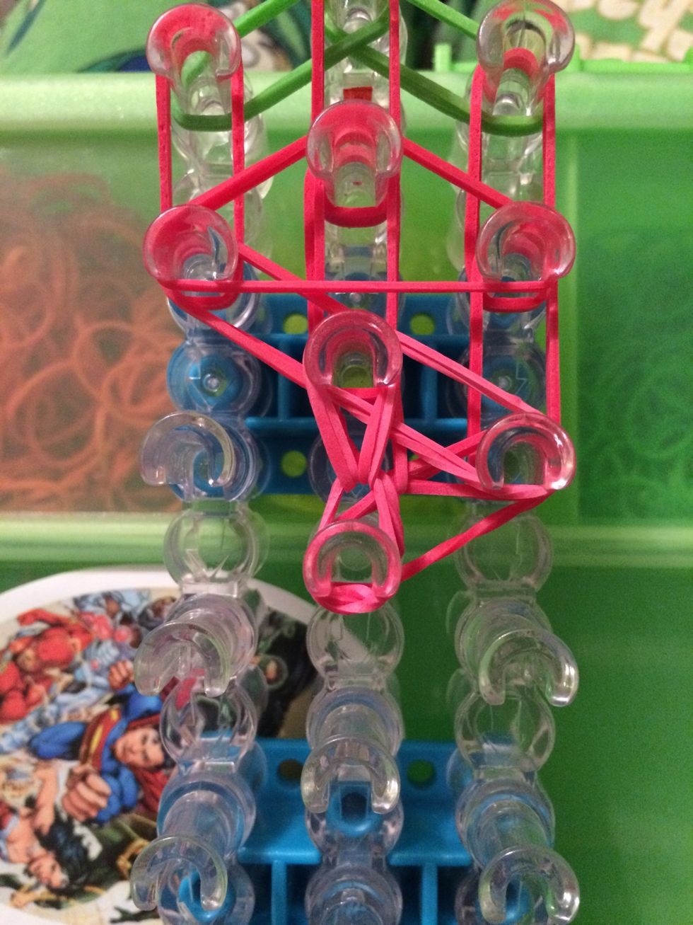 Pull it carefully to the next peg in the row. If you followed the placing of bands it will go forward.