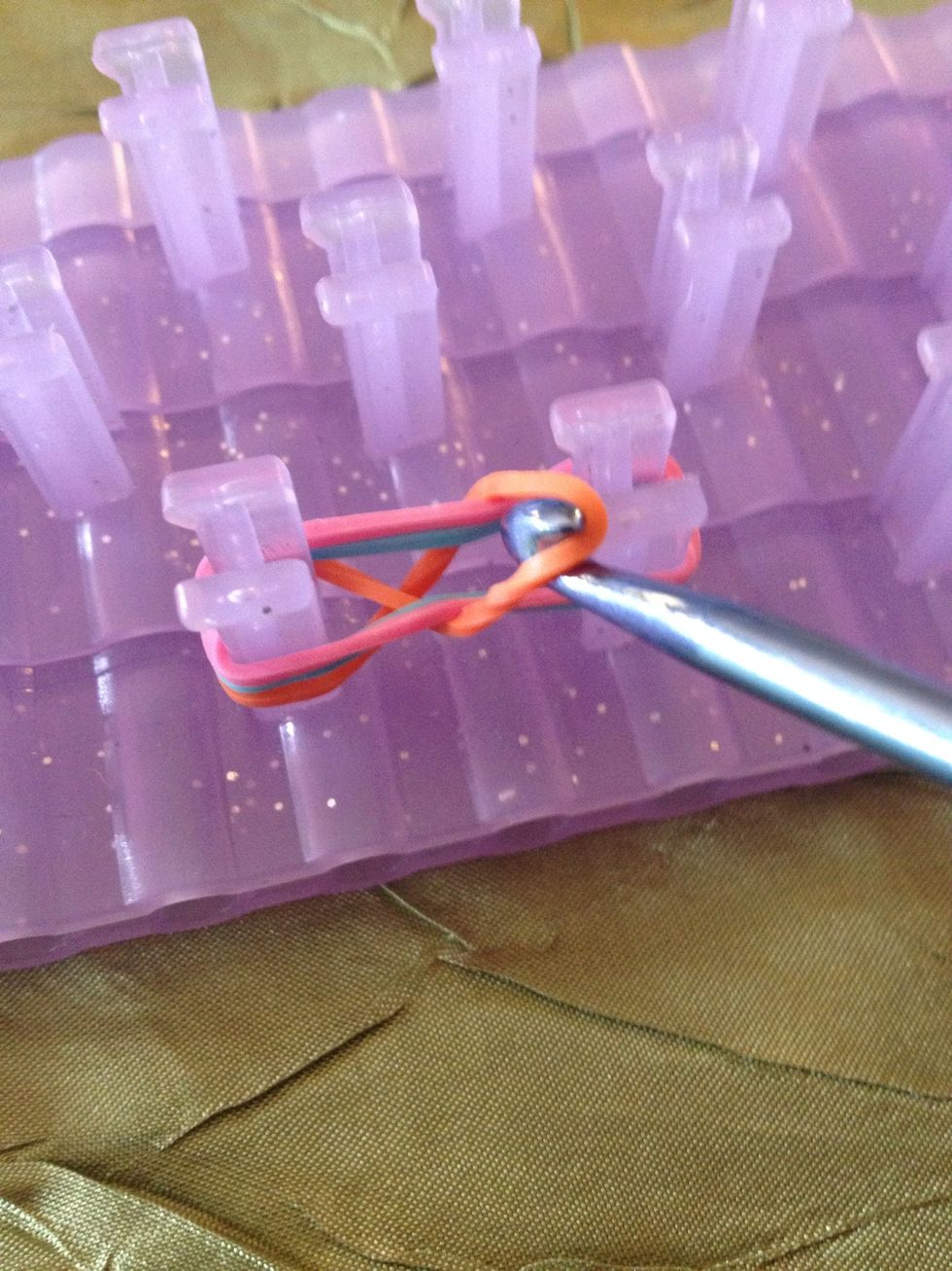 Pull it over the peg and into the middle.