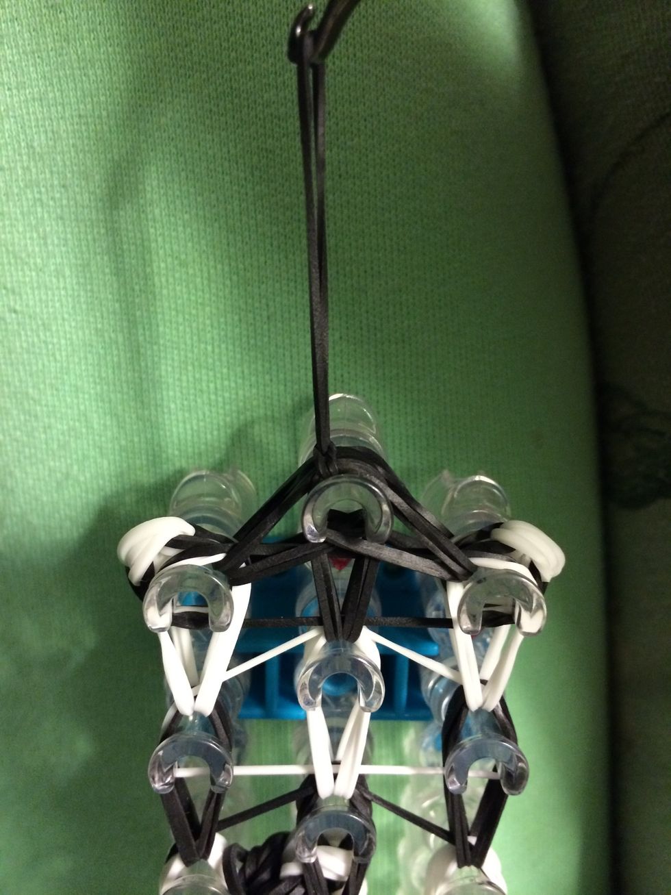 Pull it snug. Now it's time to take out zebra off the loom. Be careful when you do this and take your time.