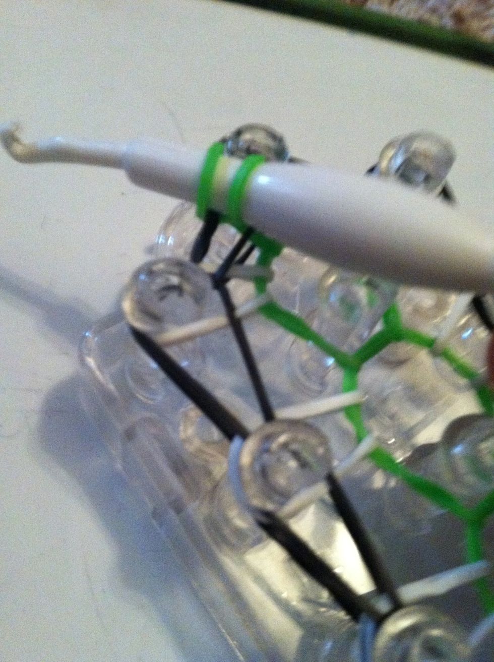 Pull it through and hook it around the hook.