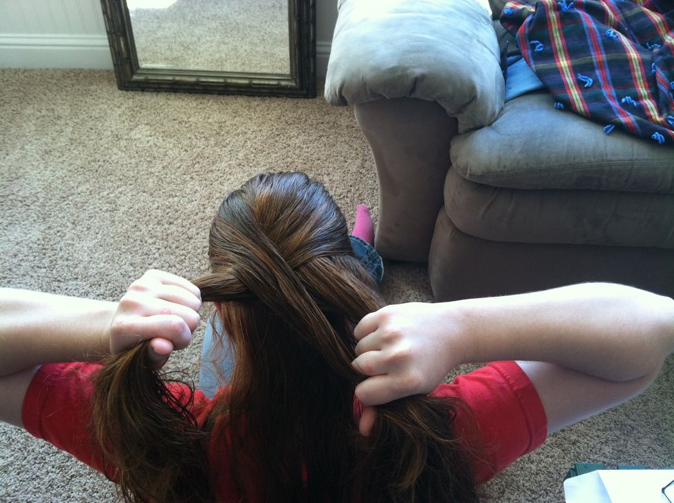 Pull it to the left so the left strand is now the new middle section