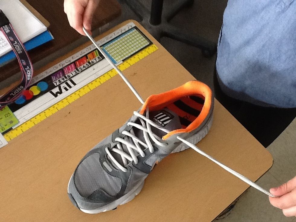 Pull laces with each hand.