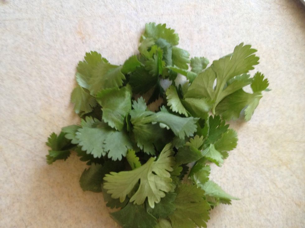 Pull leaves off of cilantro stems.