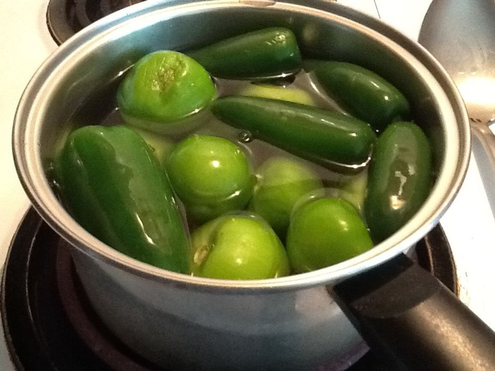 Pull of stems from chiles and pull the tomatillos them in pot with water bring to a boil