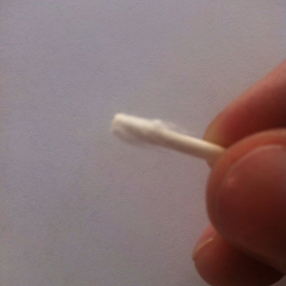 Pull off most of the cotton from the end. A little left behind is fine. Then use it to clean the headphone jack out. But be careful. Don't push hard enough to damage anything in there.