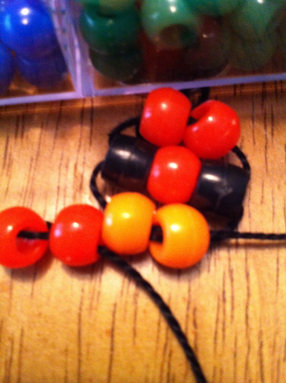 Pull on the string and push the beads upward.