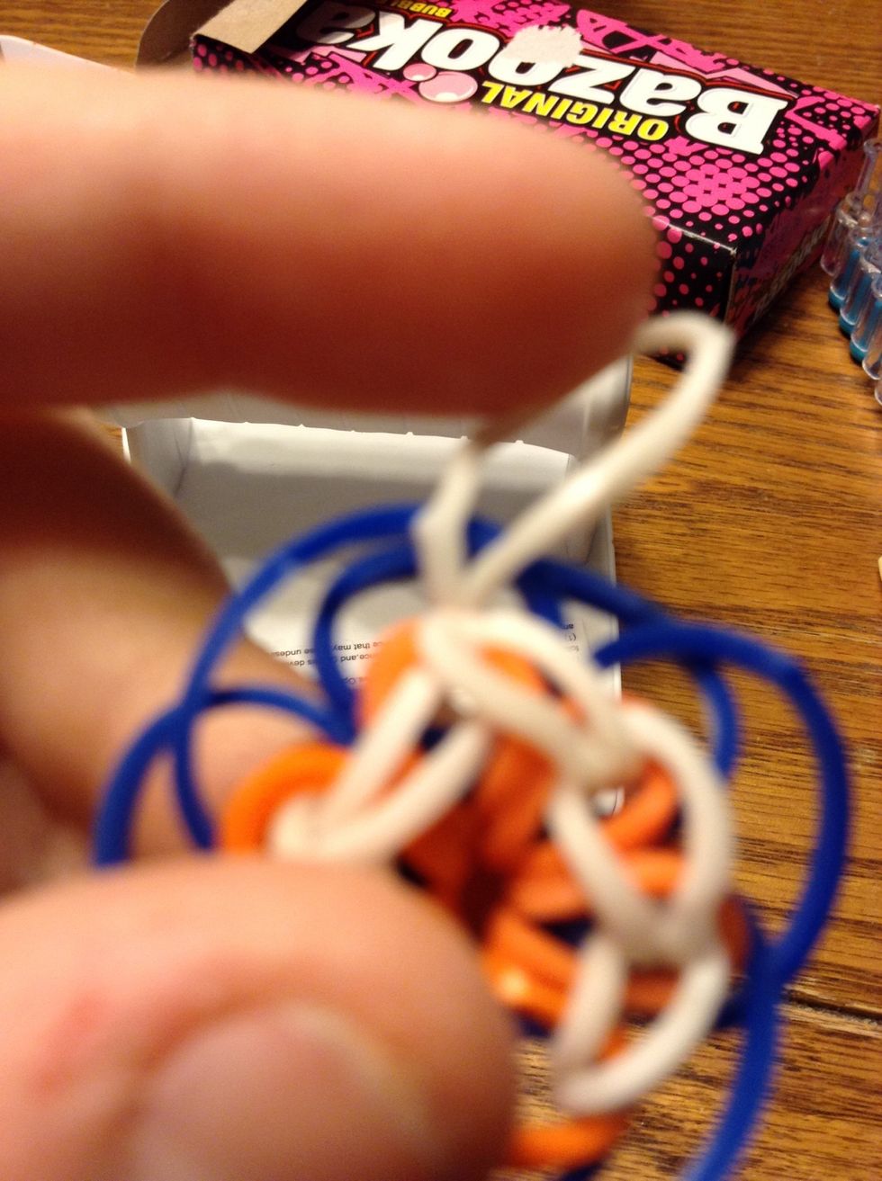 Pull one end of the band through the other end and it will make a knot.