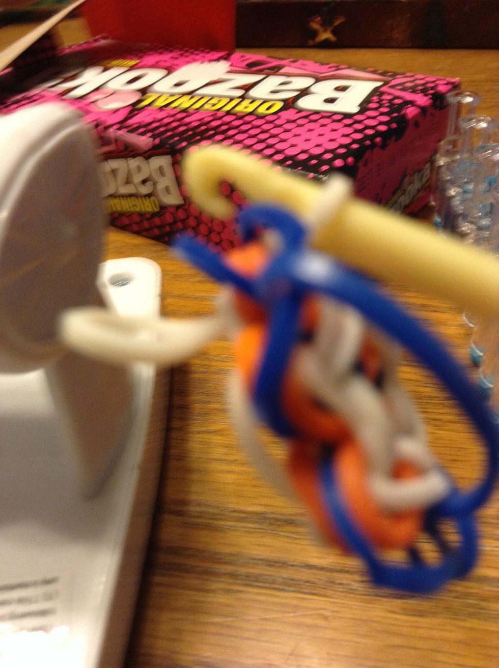 Pull one of the ends off of the hook.