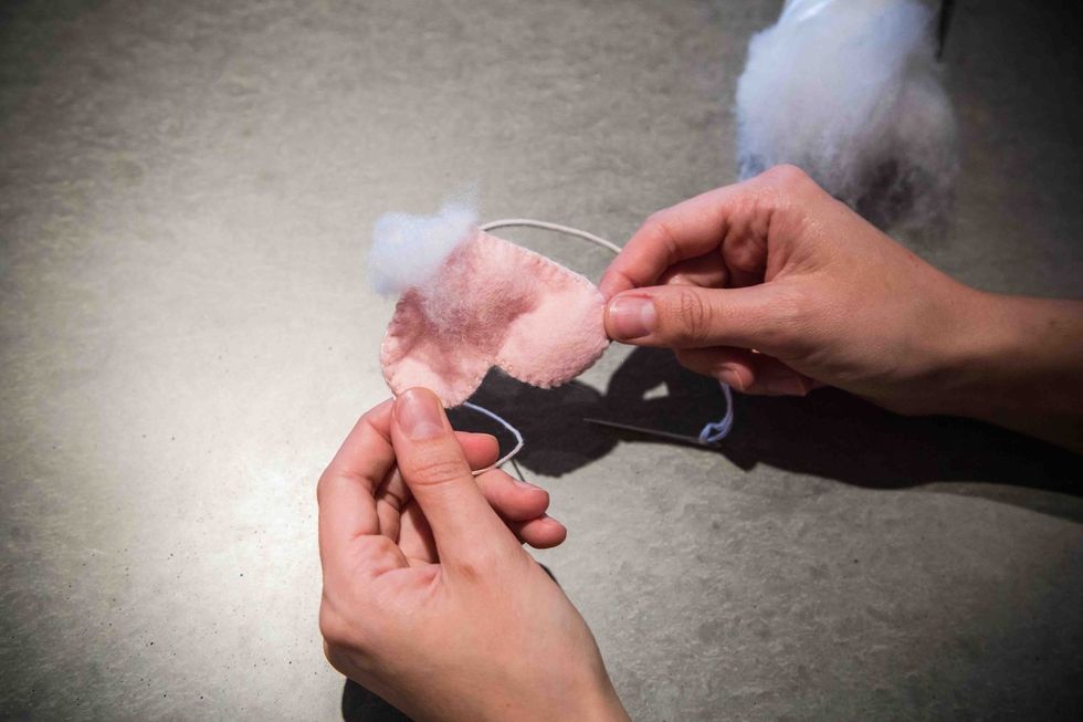 Pull open the heart and gently push the stuffing in with your fingers.