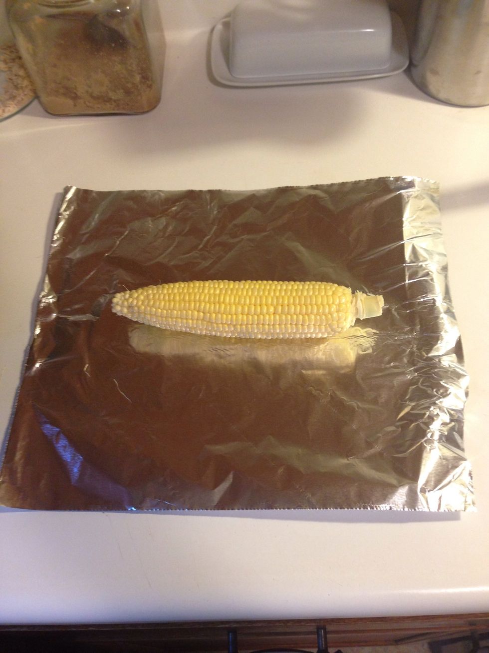 Pull out a piece of aluminum foil that is a few inches wider than your corn.