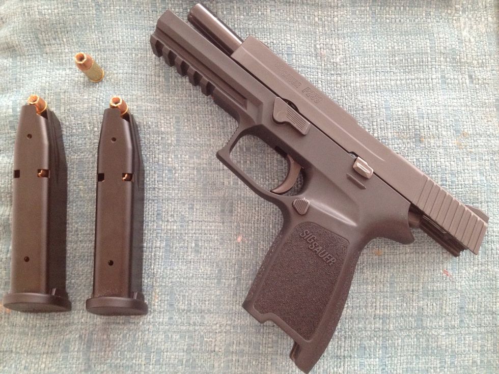 Pull slide to the rear by engaging the slide catch lever.