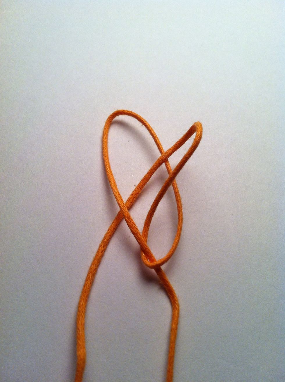 Pull sliding side partially through, making a loop and not pulling the tail end through.