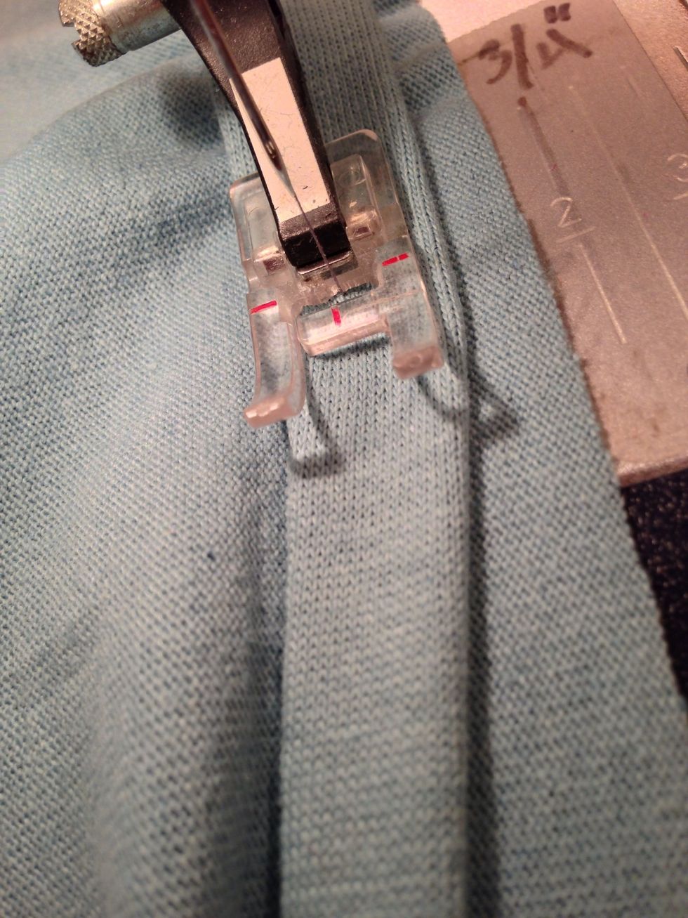 Pull slightly on the strip as you sew. You don't want to gather, you just want to stabilize, and control the stretch. Overlap a new strip when one comes to the end.