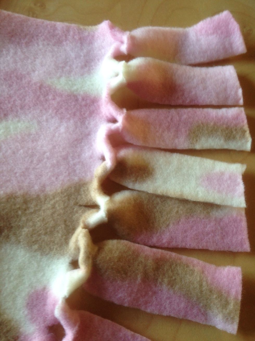 Pull taut. This looped edge makes a smoother edge than the traditional knot, and looks a bit nicer than not knotting at all.