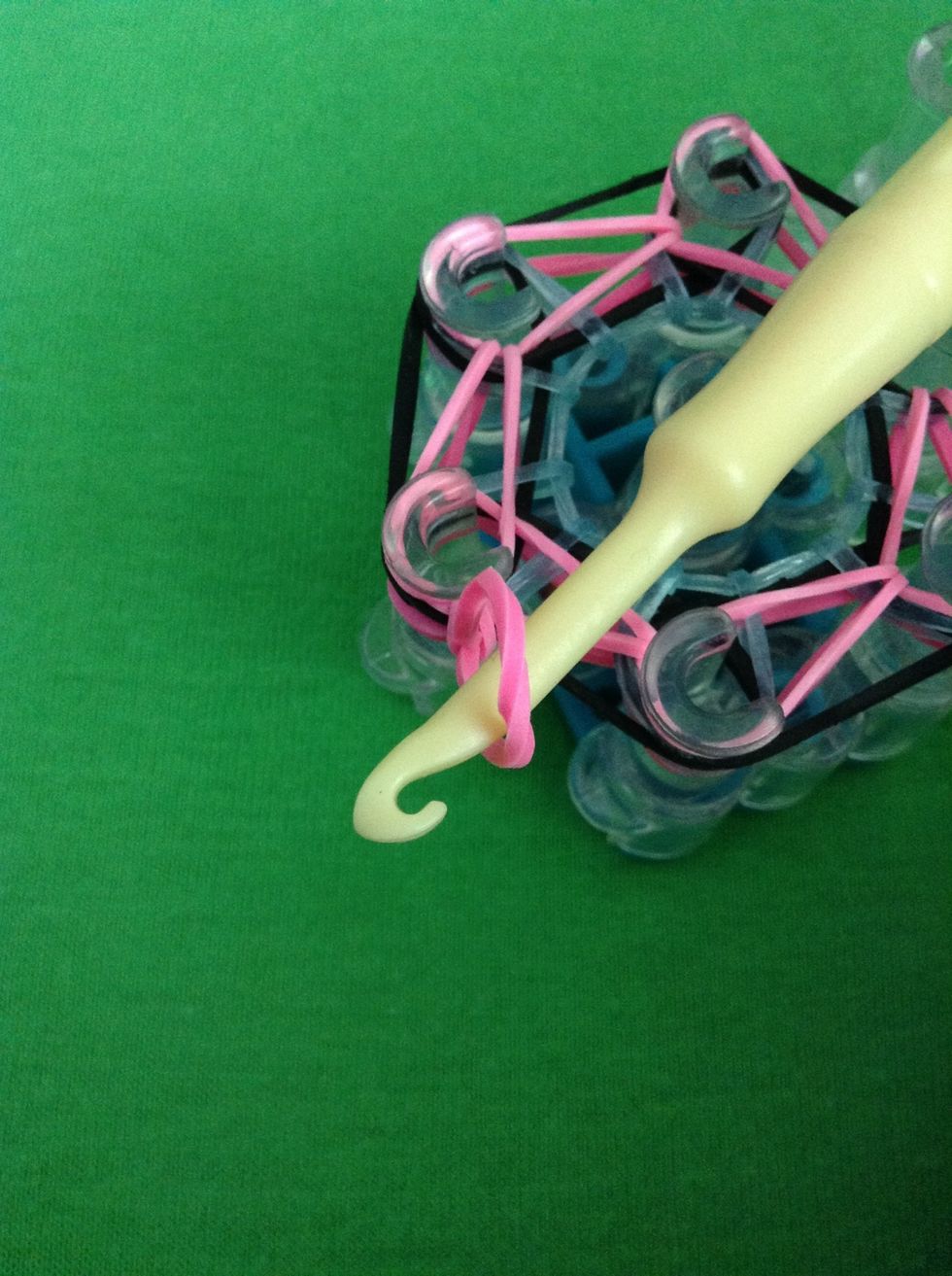 Pull the back rubber band off the hook and pull tightly so only the top part of the band is left