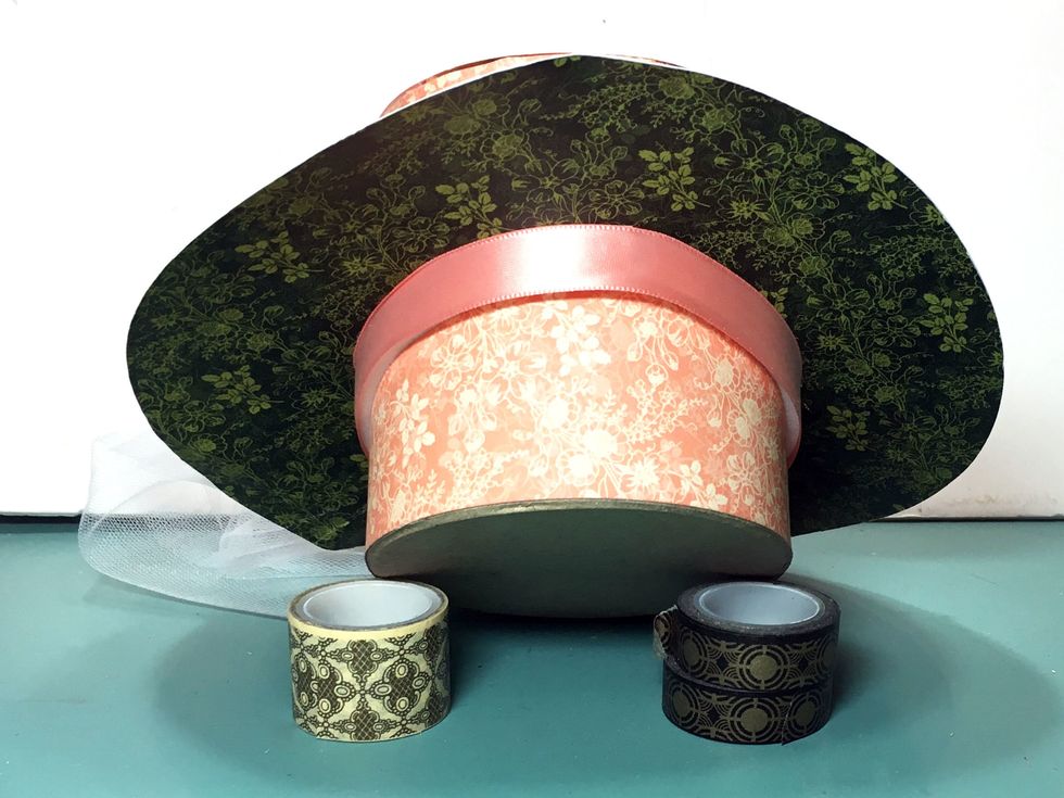 Pull the backing off the foam tape and press a ribbon onto the tape all around the hat.