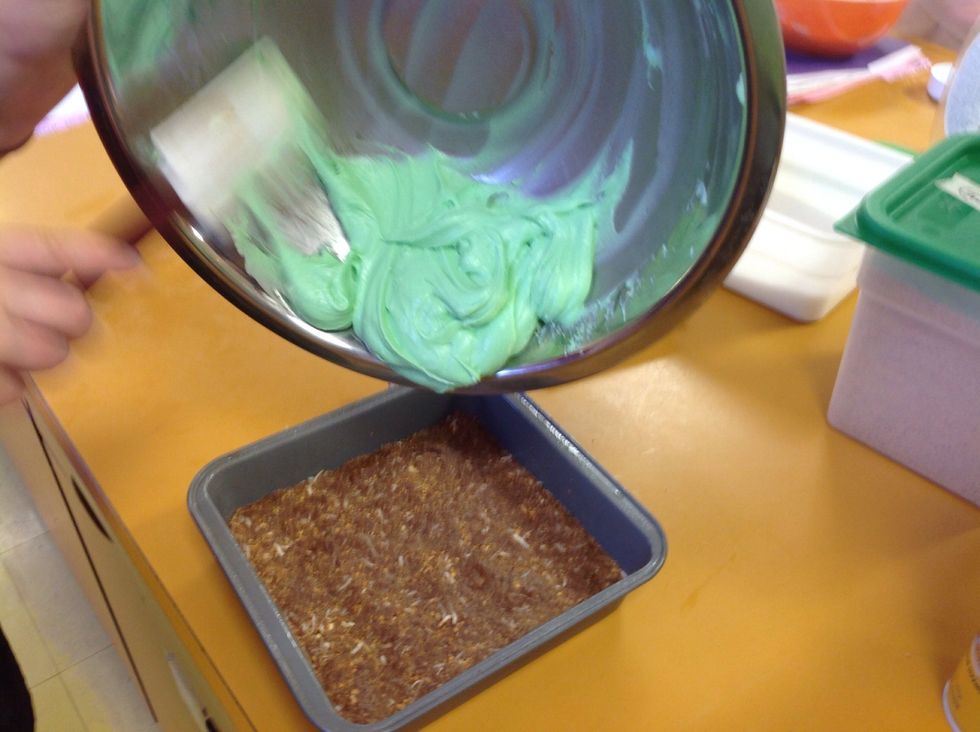 Pull the base layer out of the fridge and spread the filling layer over top of it. Smooth it out, make sure it goes to all the corners and is nice and even on top.