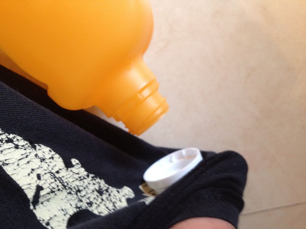 Pull the bottle out and use something to protect against burning your fingers. I used my shirt, but it may be better to use oven mitts. Twist the cap off while the plastic is soft.