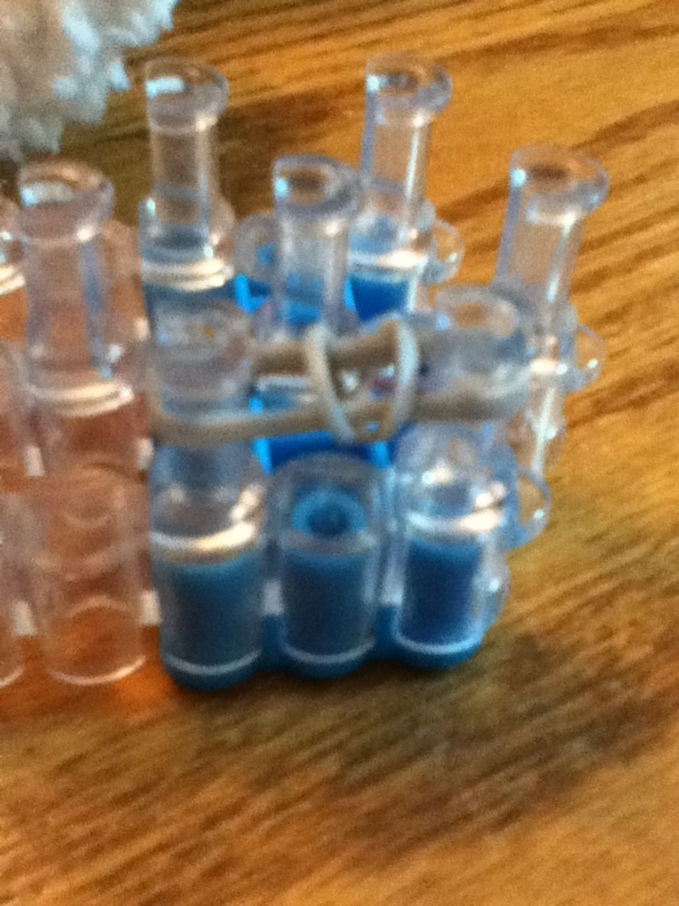 Pull the bottom rubber band over the top two