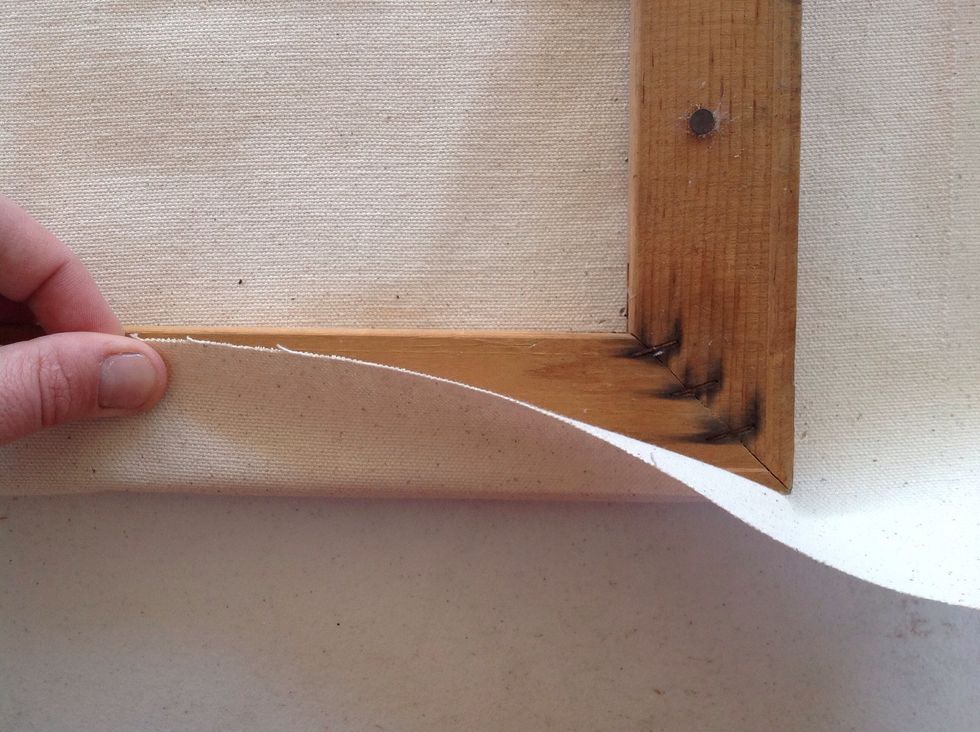 Pull the canvas up around the edge of the frame and make sure there is enough room for stapling. Roughly 2 inches should work.