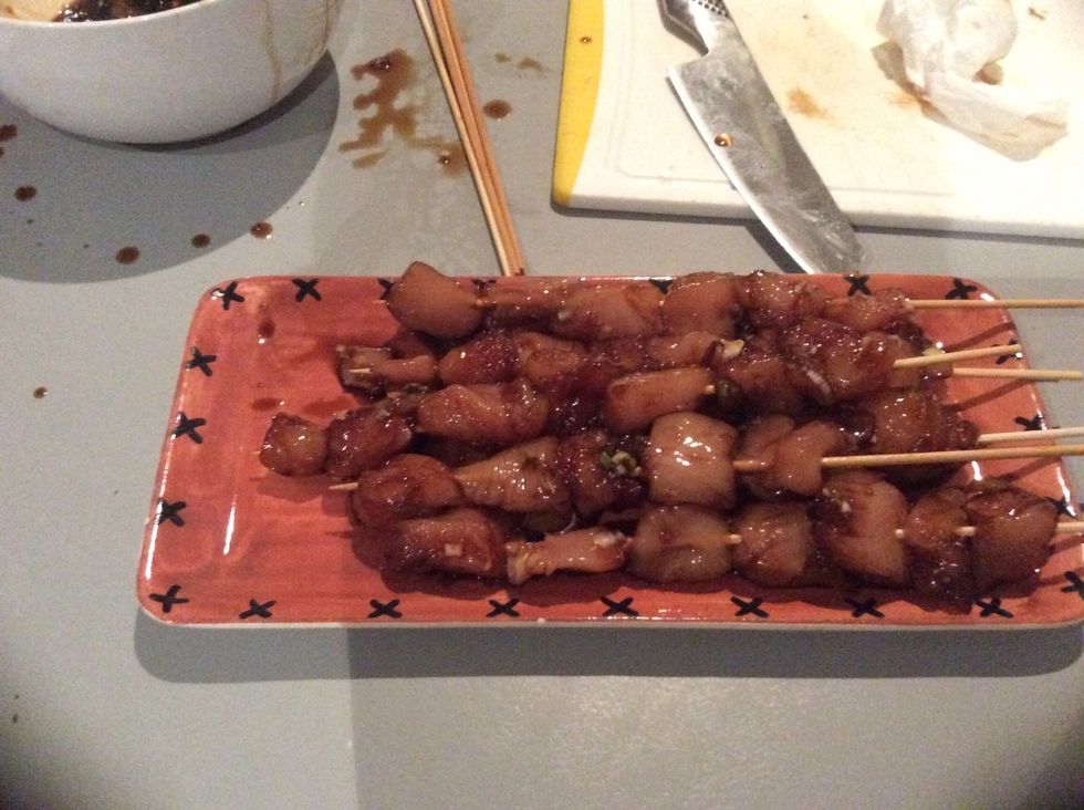 Pull the chicken out of the fridge and place all the chicken on skewers with Little gaps in between for a better cook