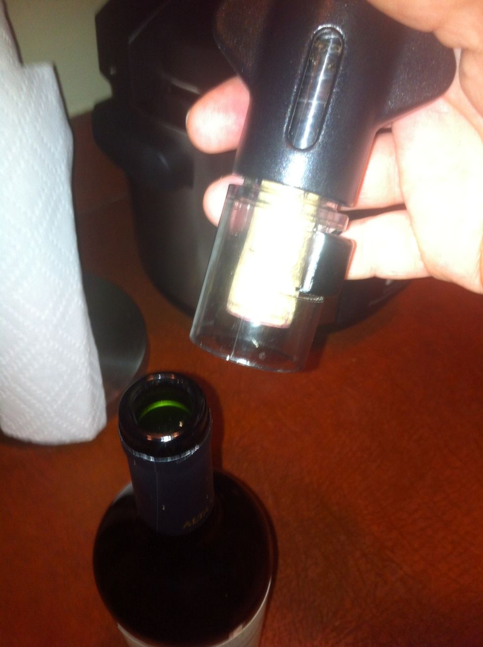 Pull the cork from the bottle. It's okay to say "Opa" or "ta-da" at this point, the worst part is over.