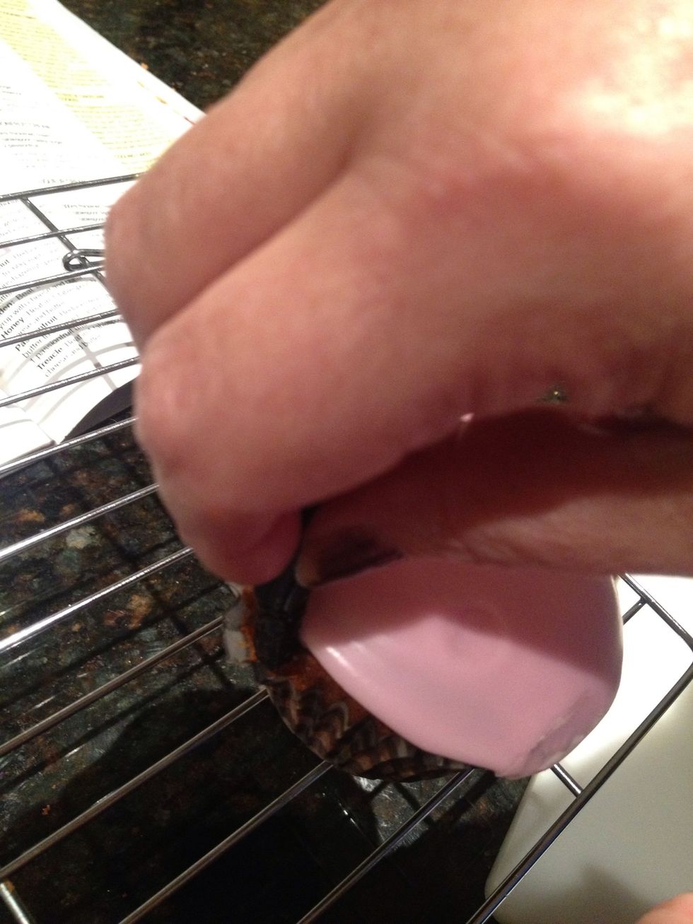 Pull the cupcake wrapper out and place one end of the licorice in to the side of the cupcake. Repeat to the other side of the cupcake and push the cupcake wrapper back in to keep the licorice in place