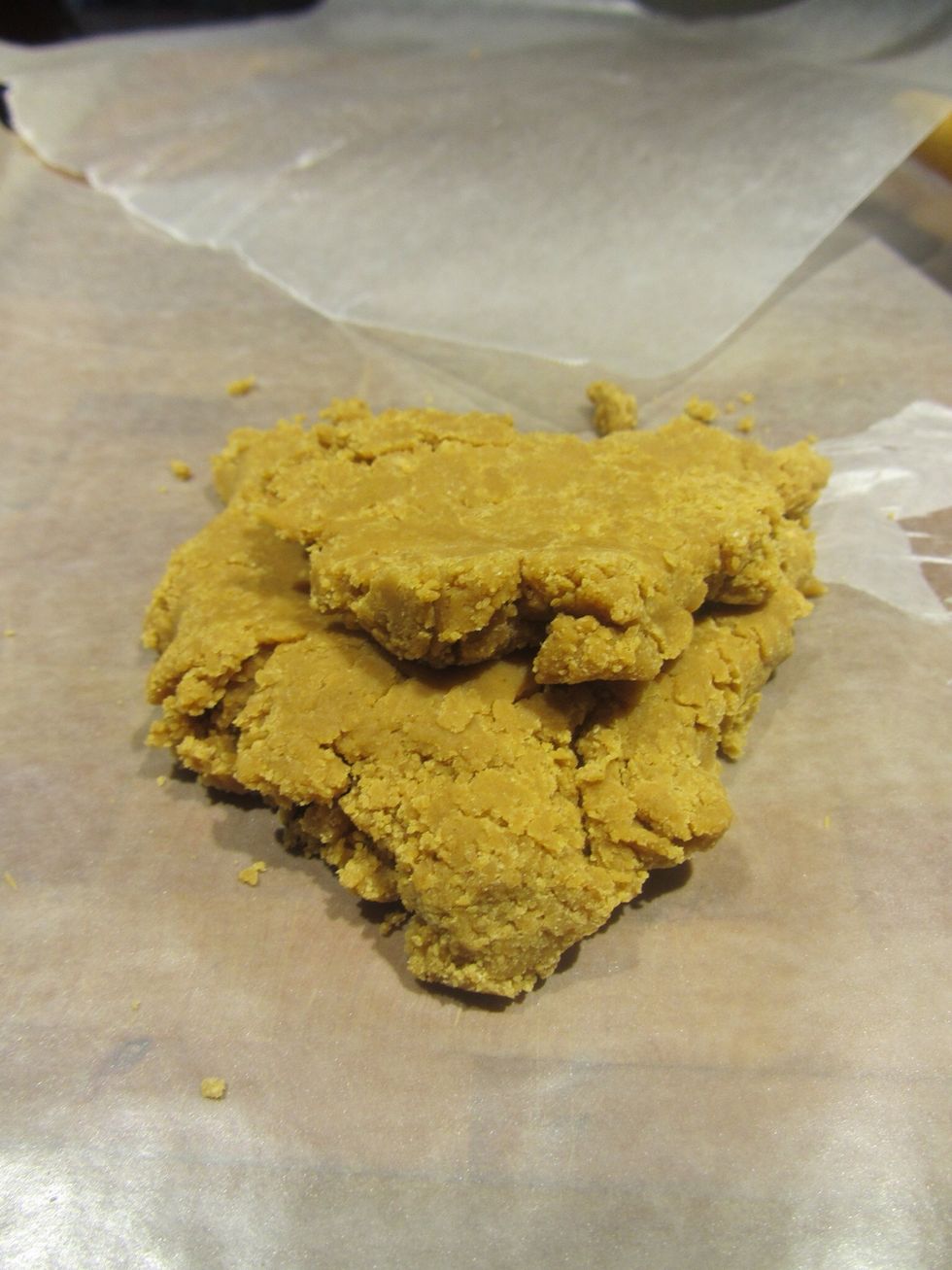 Pull the dough into a ball and set between two sheets of wax paper.