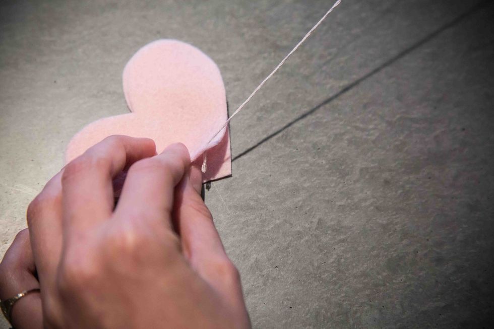 Pull the embroidery floss all the way through until you reach the knot.