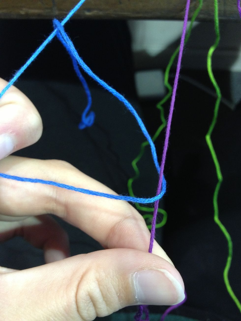 Pull the end of the outside string through the loop and pull tight! I like to make my knots really tight but it's your preference. You make two knots like this per string. Remember: OVER AND THROUGH!