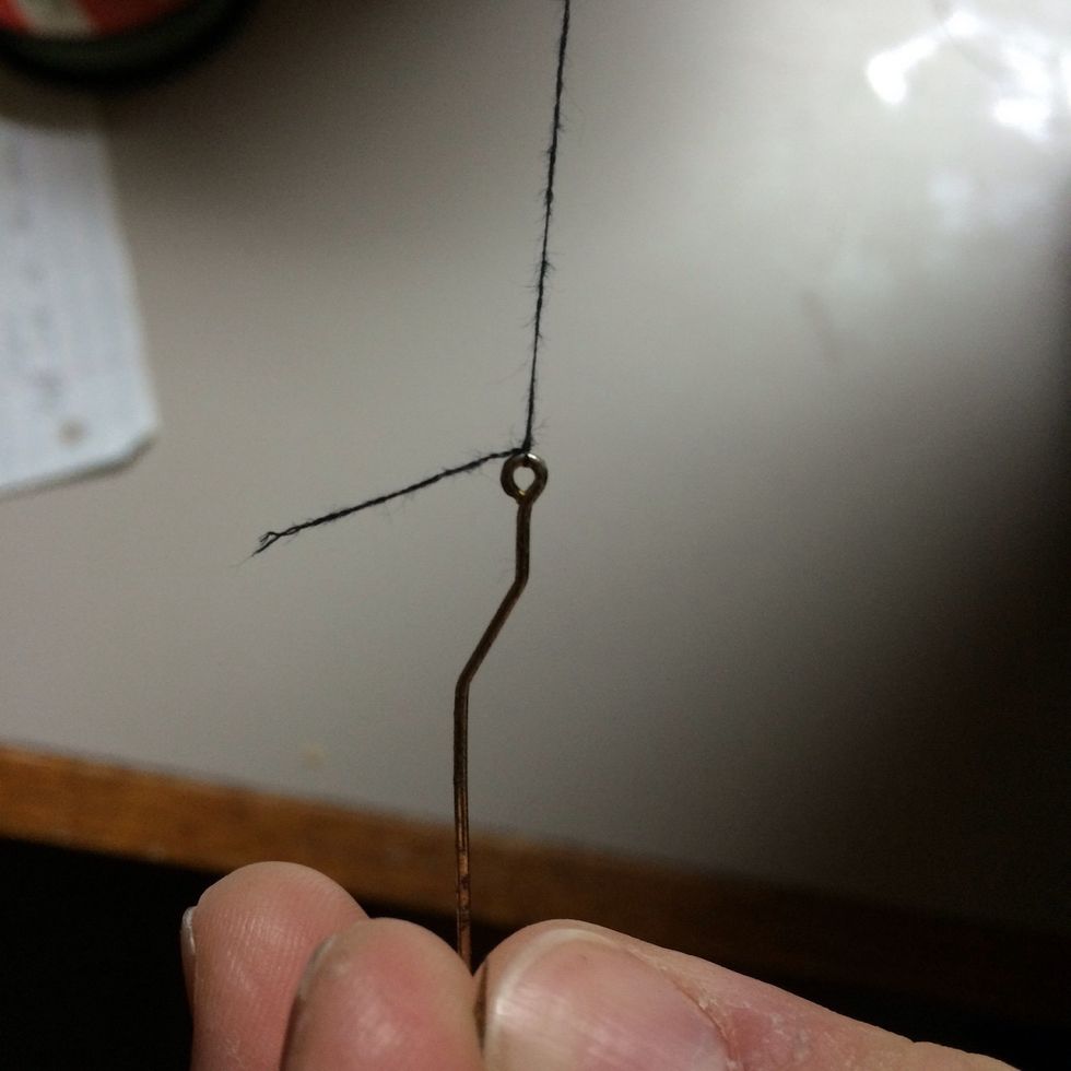 Pull the free end through the loop than grab the longest line than the hook and pull it down tight till it is bundled up by the eye tight