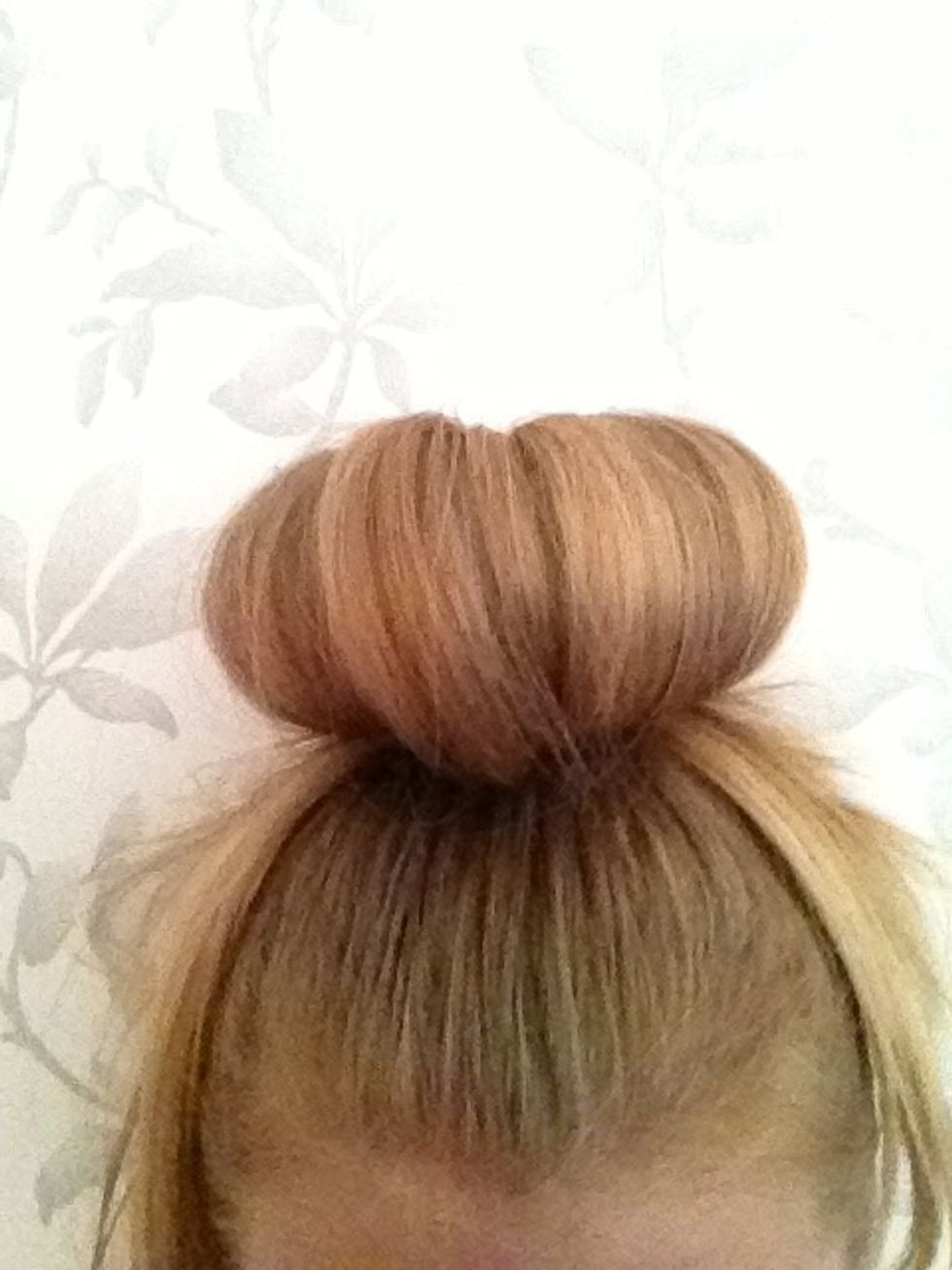 Pull the hair round the donut and put a small, thin, tight bobble around it