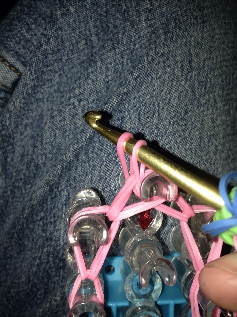 Pull the hook back through the bands and place the other end of the rubber band on the hook. Don't let go of the other end of the band as you pull it through.