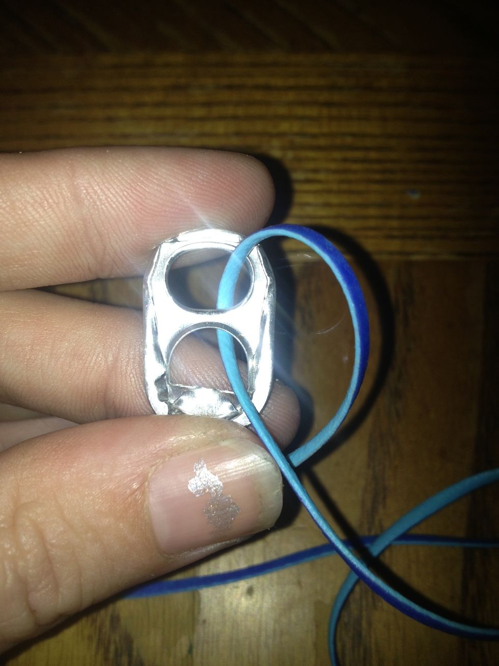 Pull the lace ends all the way through the soda tab.