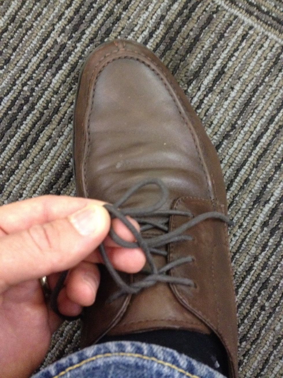 Pull the lace you just wrapped through middle making a second loop.