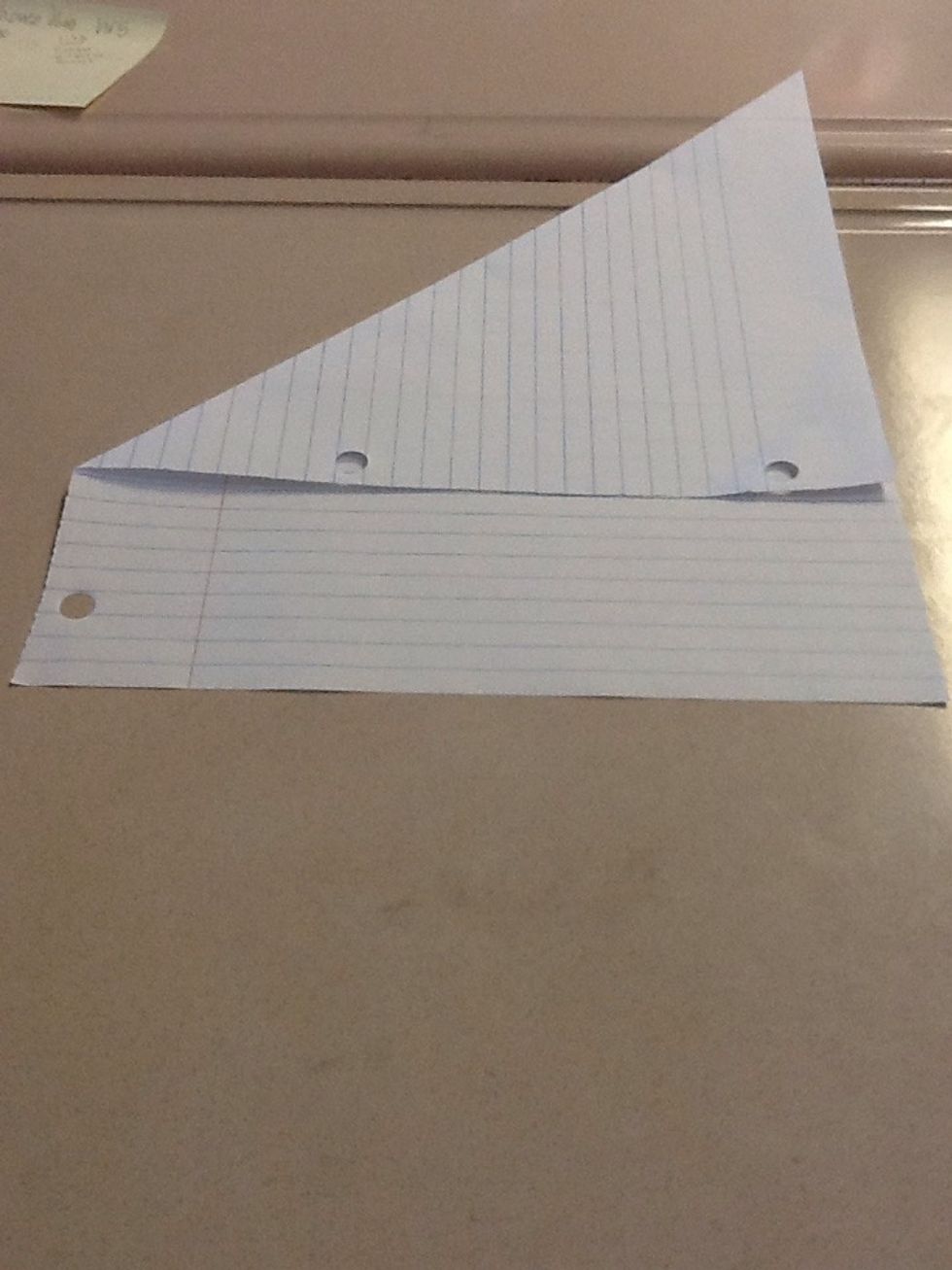 Pull the left corner to the middle of the right side, then align the sides.