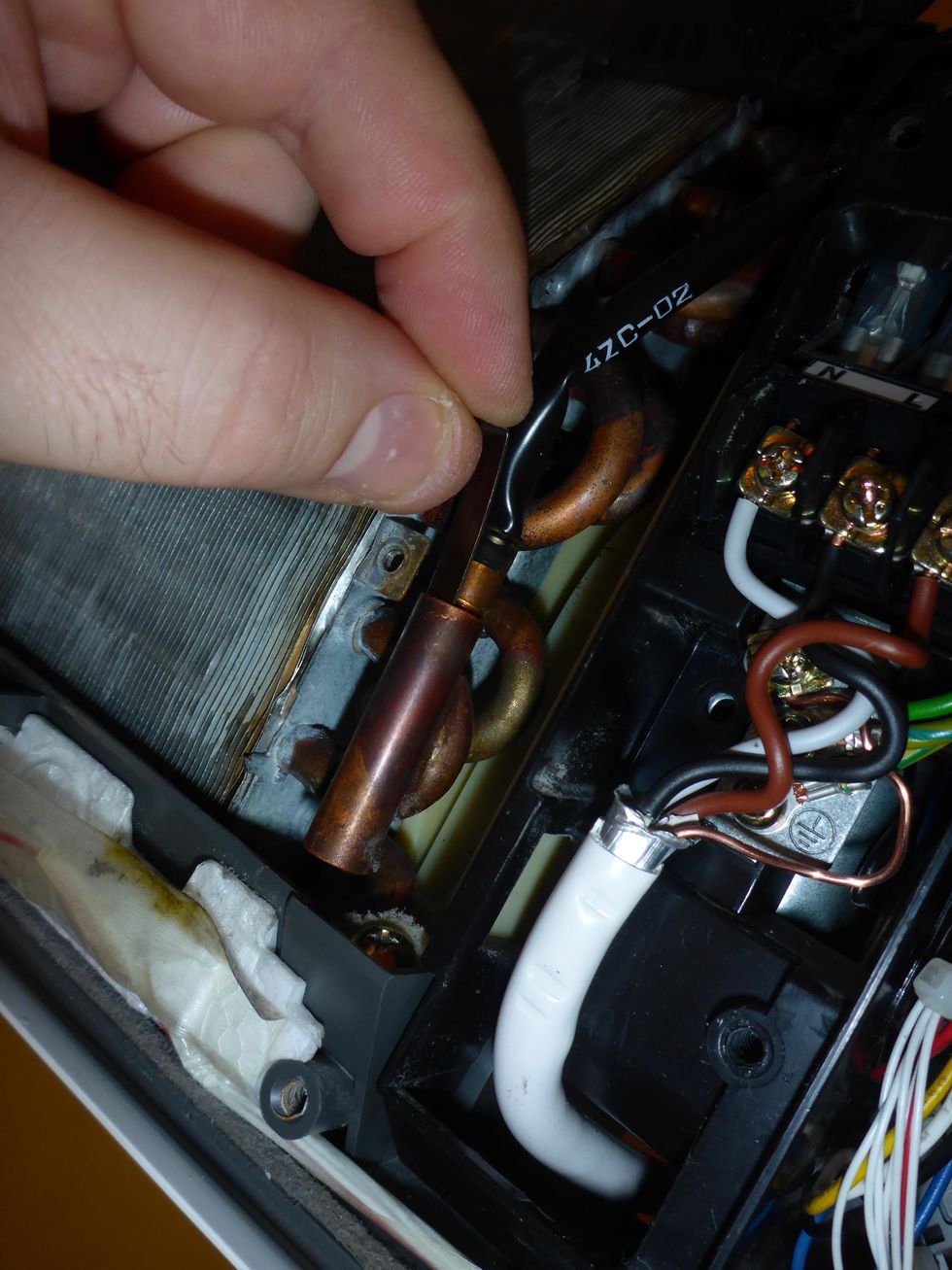 Pull the locking pin and temperature sensor out of the socket.