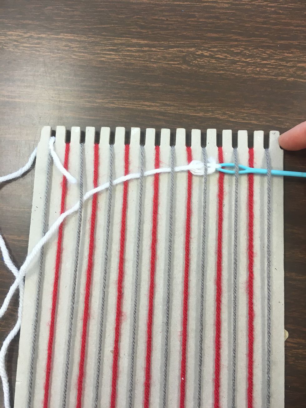 Pull the needle through, and the yarn with follow.