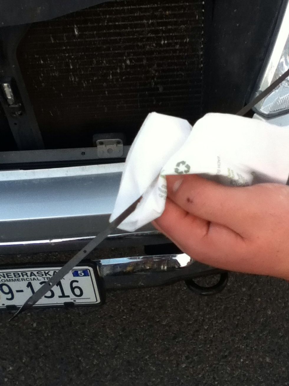 Pull the oil stick back out from the hole. Look to see if the oil is in between the two dots. If not, you will need to add more oil. Also check the color of the oil.