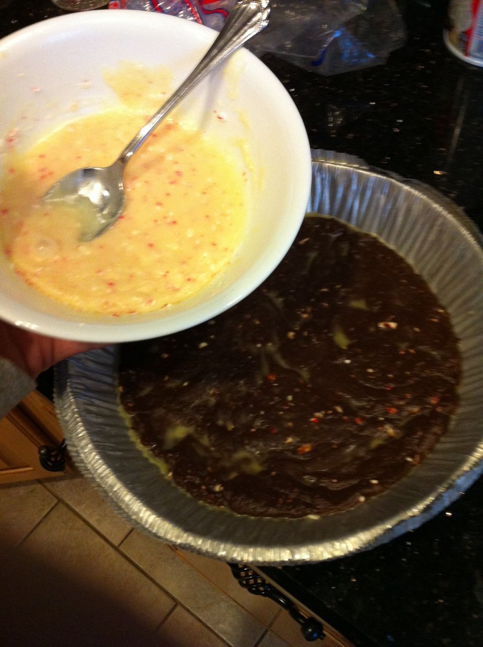 Pull the pan out of the freezer and get the white chocolate ready to pour on top of the hard milk chocolate